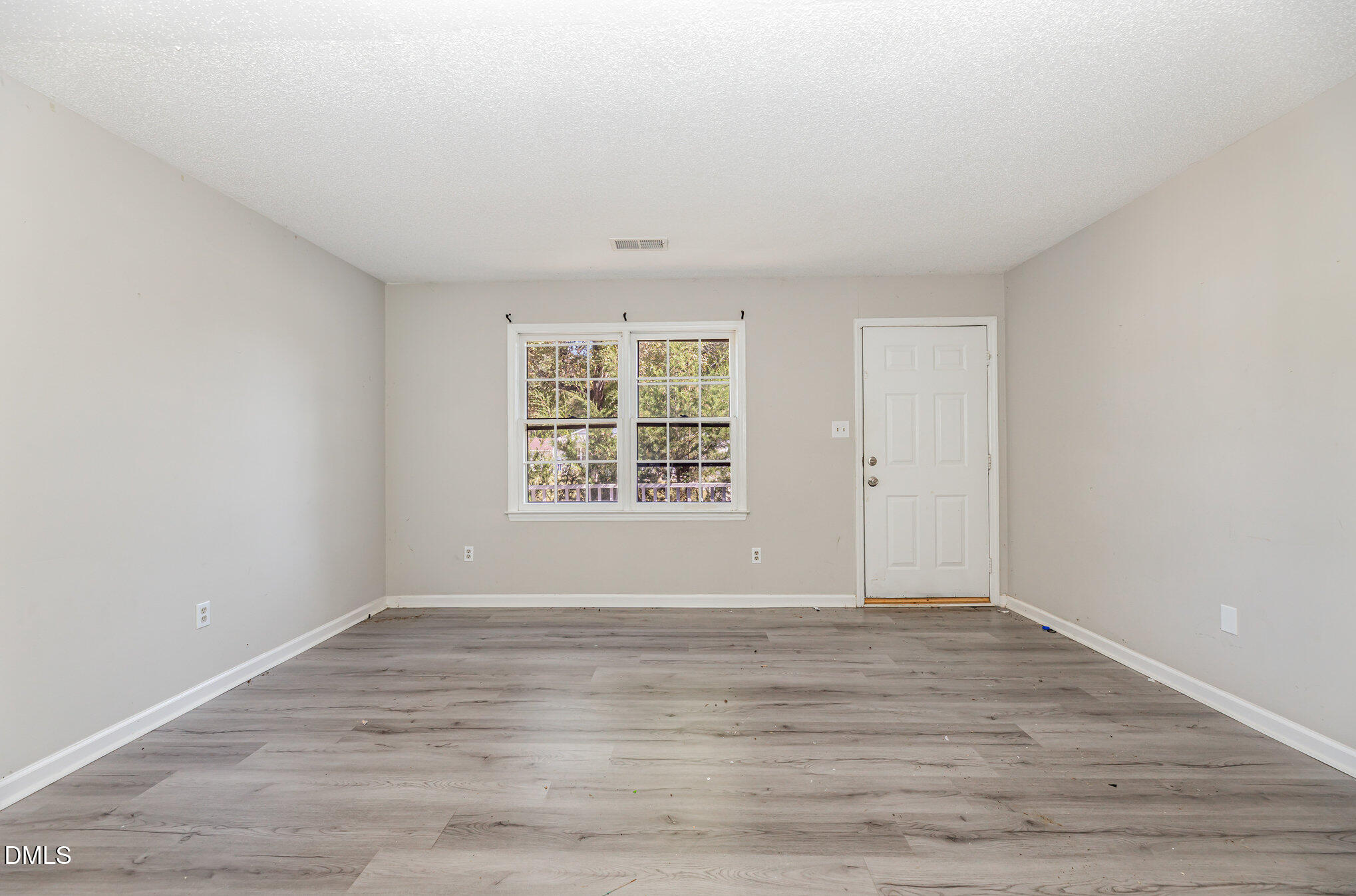 517 Carter Road Graham, NC 27253 - Photo 6 of 27 a view of an empty room with wooden floor and a window