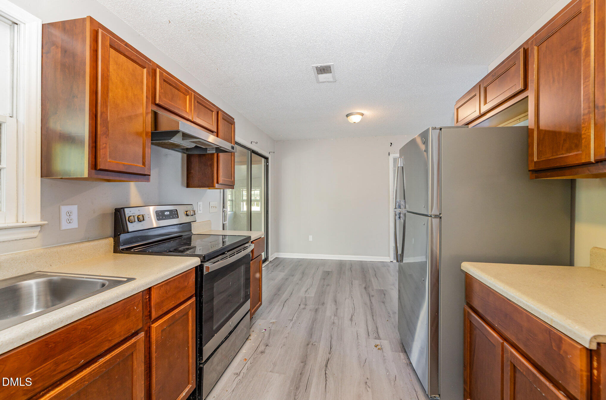 517 Carter Road Graham, NC 27253 - Photo 9 of 27 a kitchen with stainless steel appliances granite countertop a refrigerator a sink dishwasher a stove top oven with wooden floor