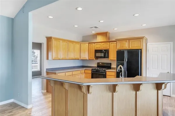 a view of a kitchen with microwave and cabinets