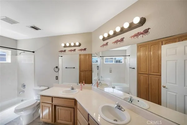 a view of a storage and utility room with washer and dryer
