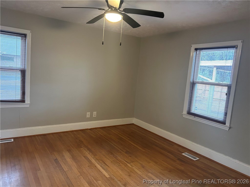 1700 Cedar Creek Road Fayetteville, NC 28312 - Photo 13 of 31 wooden floor in an empty room with a window