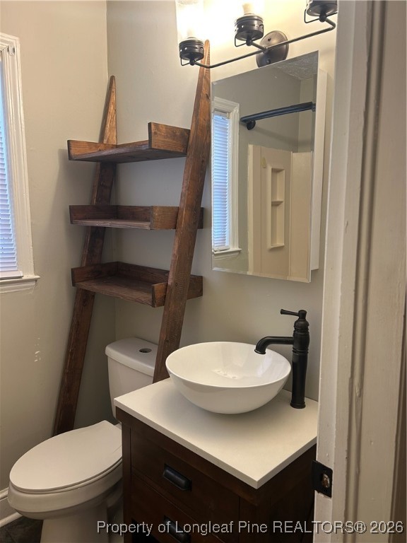 1700 Cedar Creek Road Fayetteville, NC 28312 - Photo 25 of 31 a bathroom with a toilet sink and mirror
