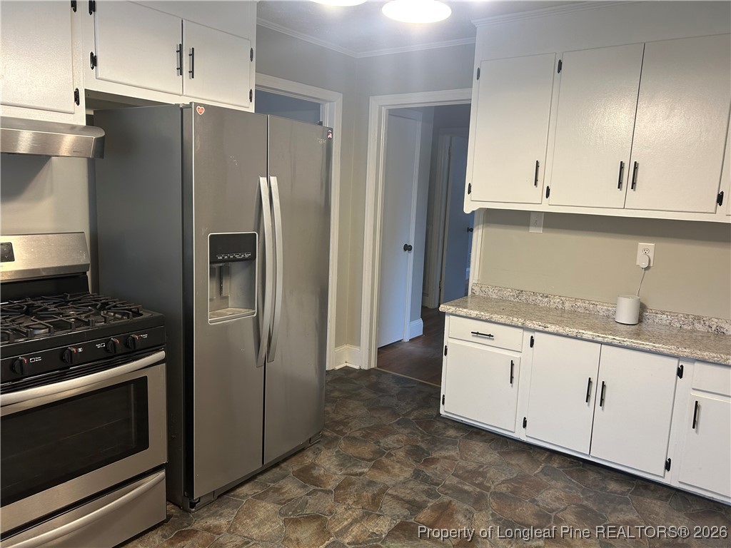 1700 Cedar Creek Road Fayetteville, NC 28312 - Photo 9 of 31 a kitchen with granite countertop white cabinets and stainless steel appliances
