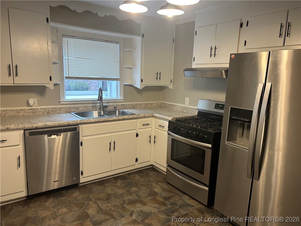 1700 Cedar Creek Road Fayetteville, NC 28312 - Photo 10 of 31 a kitchen with a sink stove and refrigerator