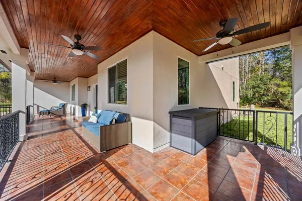 a living room with furniture and a piano