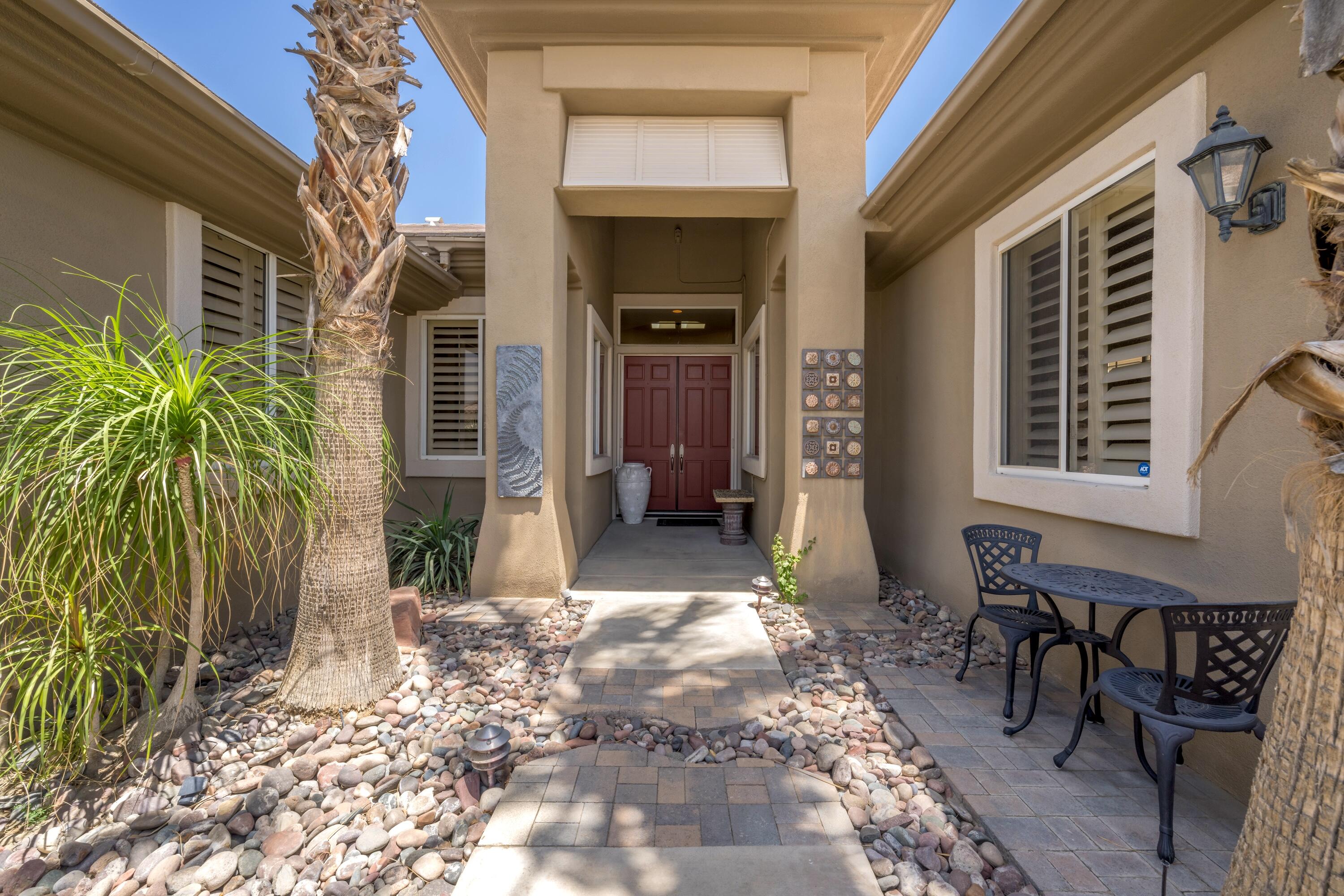 39623 Manorgate Road Palm Desert, CA 92211 - Photo 14 of 42 a front view of a house with a porch
