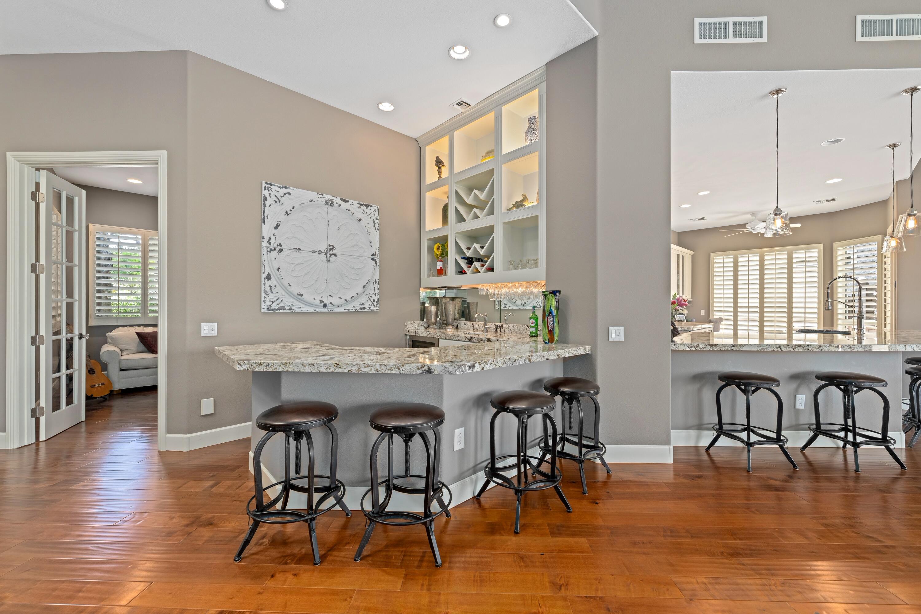 39623 Manorgate Road Palm Desert, CA 92211 - Photo 15 of 42 a view of a a dining room with furniture window and wooden floor