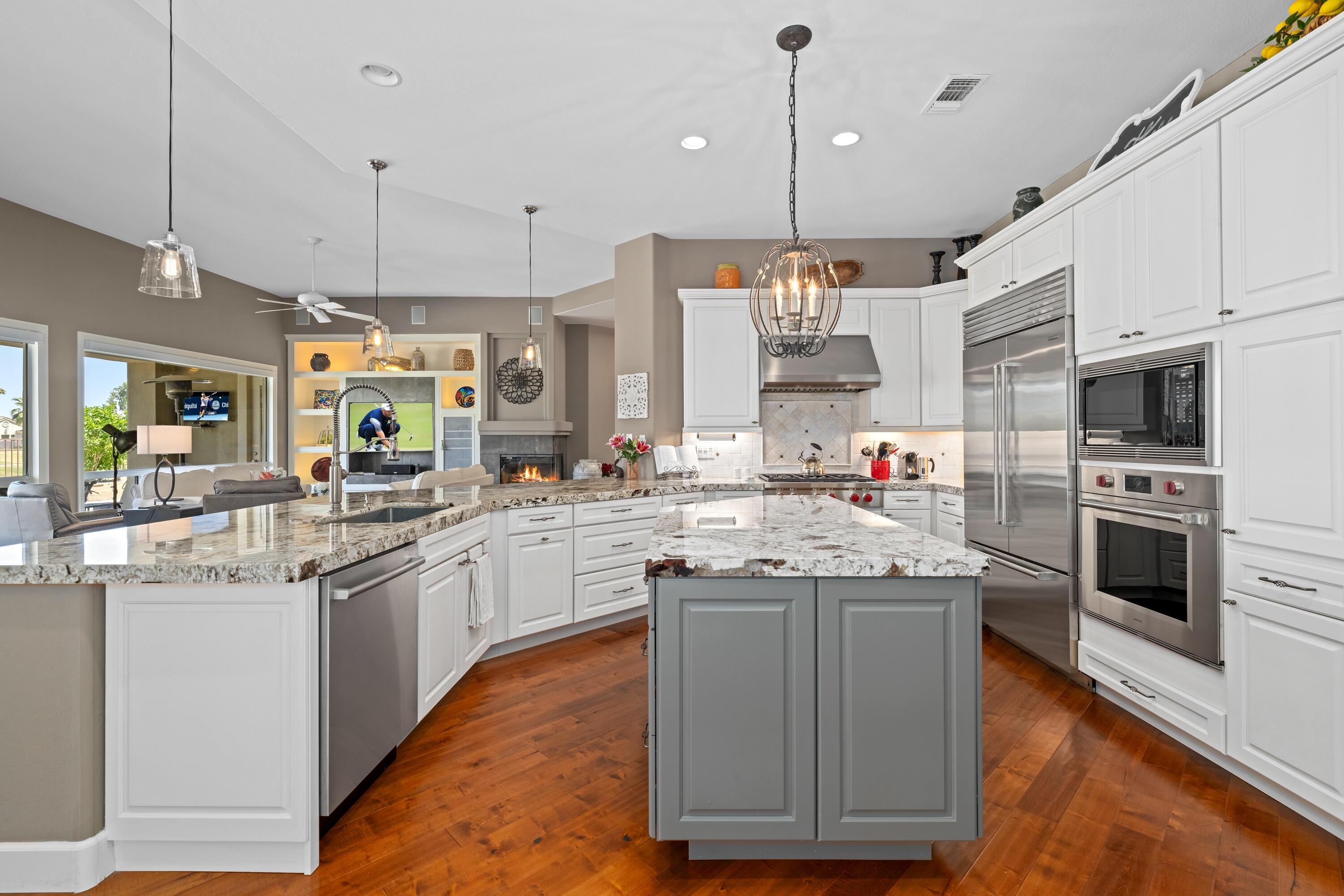 39623 Manorgate Road Palm Desert, CA 92211 - Photo 23 of 42 a kitchen with stainless steel appliances granite countertop wooden cabinets and a stove
