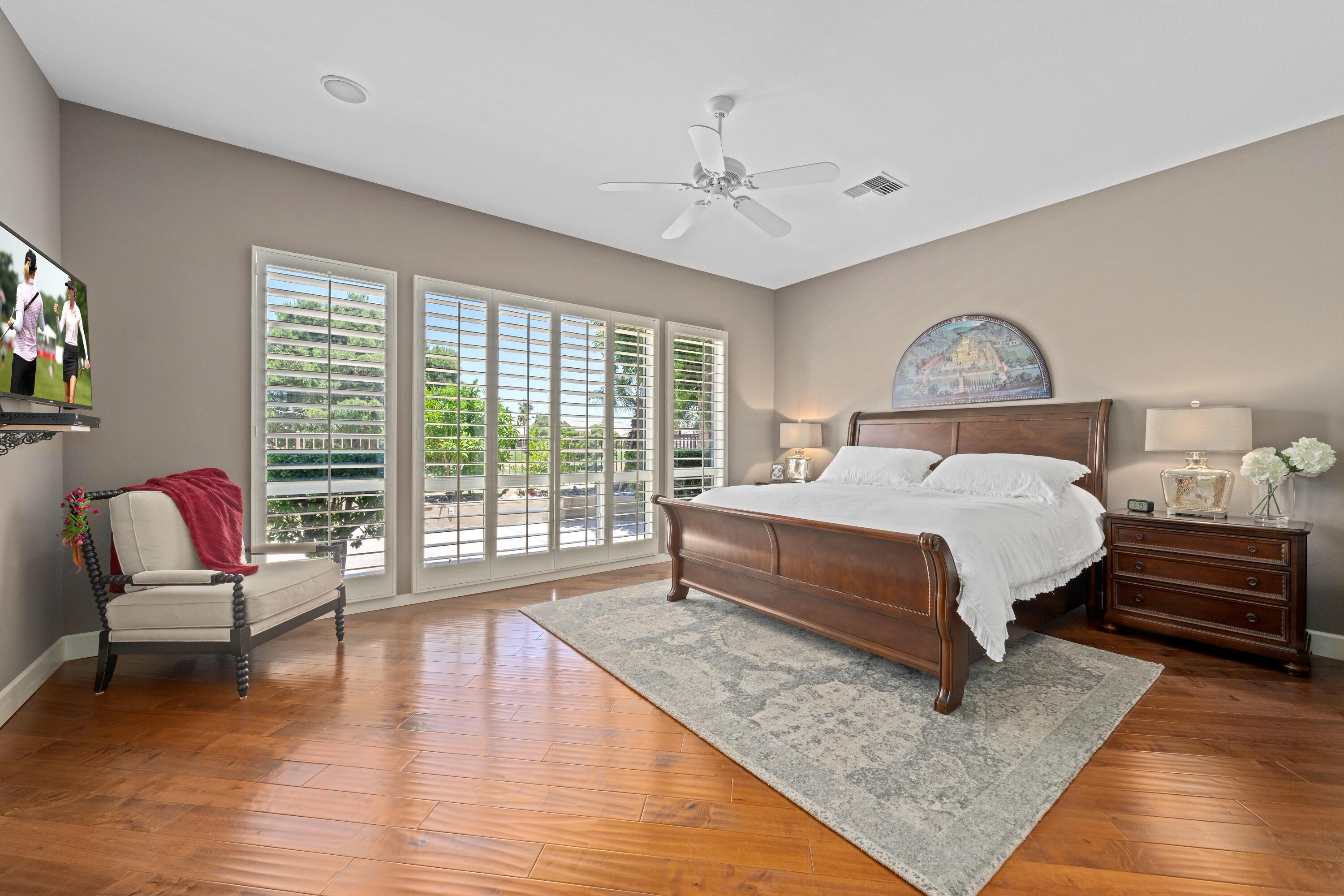 39623 Manorgate Road Palm Desert, CA 92211 - Photo 27 of 42 a spacious bedroom with a bed a couch and a window
