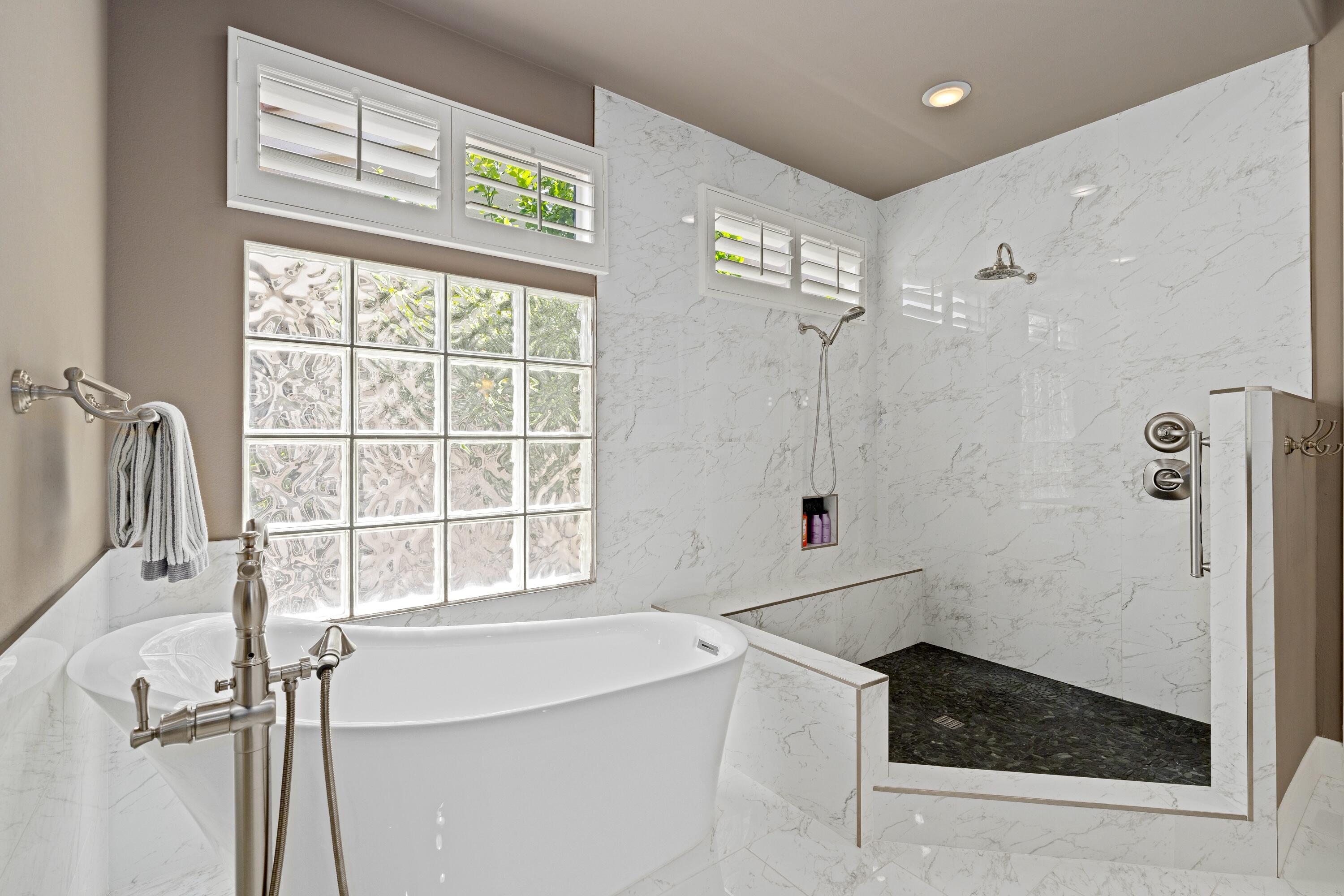 39623 Manorgate Road Palm Desert, CA 92211 - Photo 31 of 42 a bathroom with a granite countertop sink a large mirror and shower