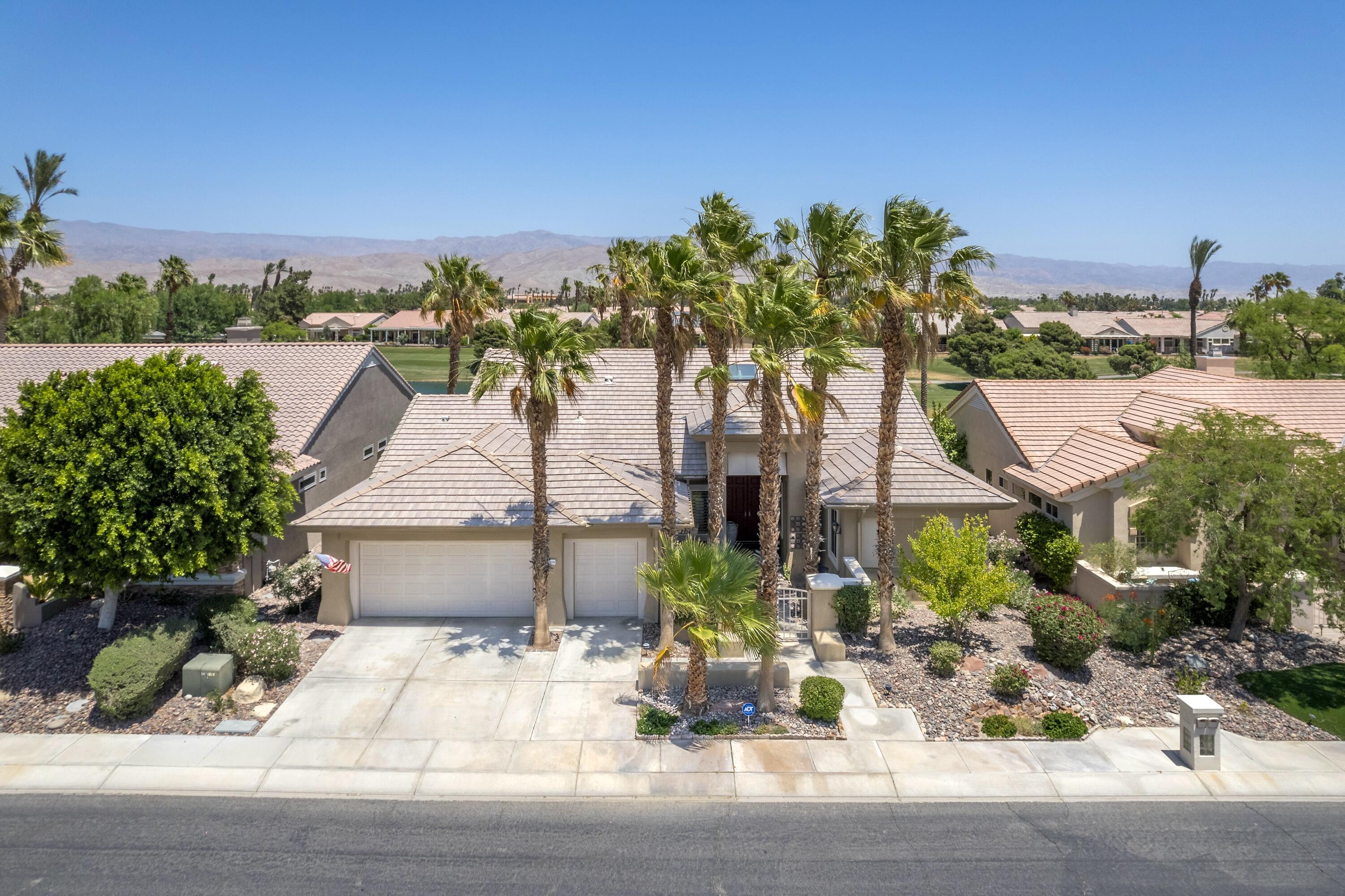 39623 Manorgate Road Palm Desert, CA 92211 - Photo 38 of 42 a front view of a house with a yard and street