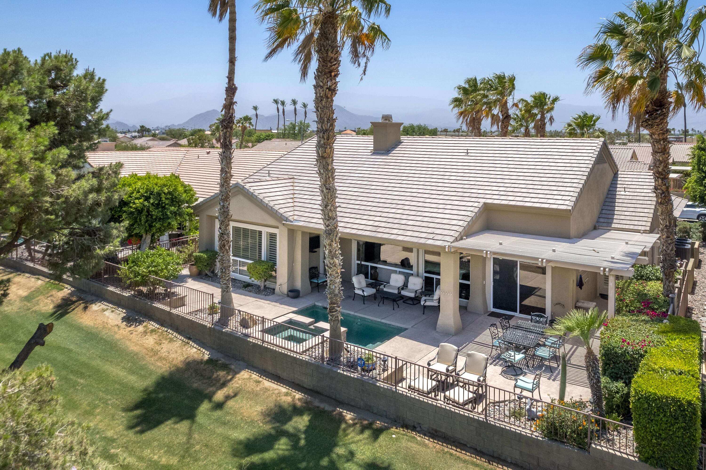 39623 Manorgate Road Palm Desert, CA 92211 - Photo 41 of 42 a house view with a garden and swimming pool