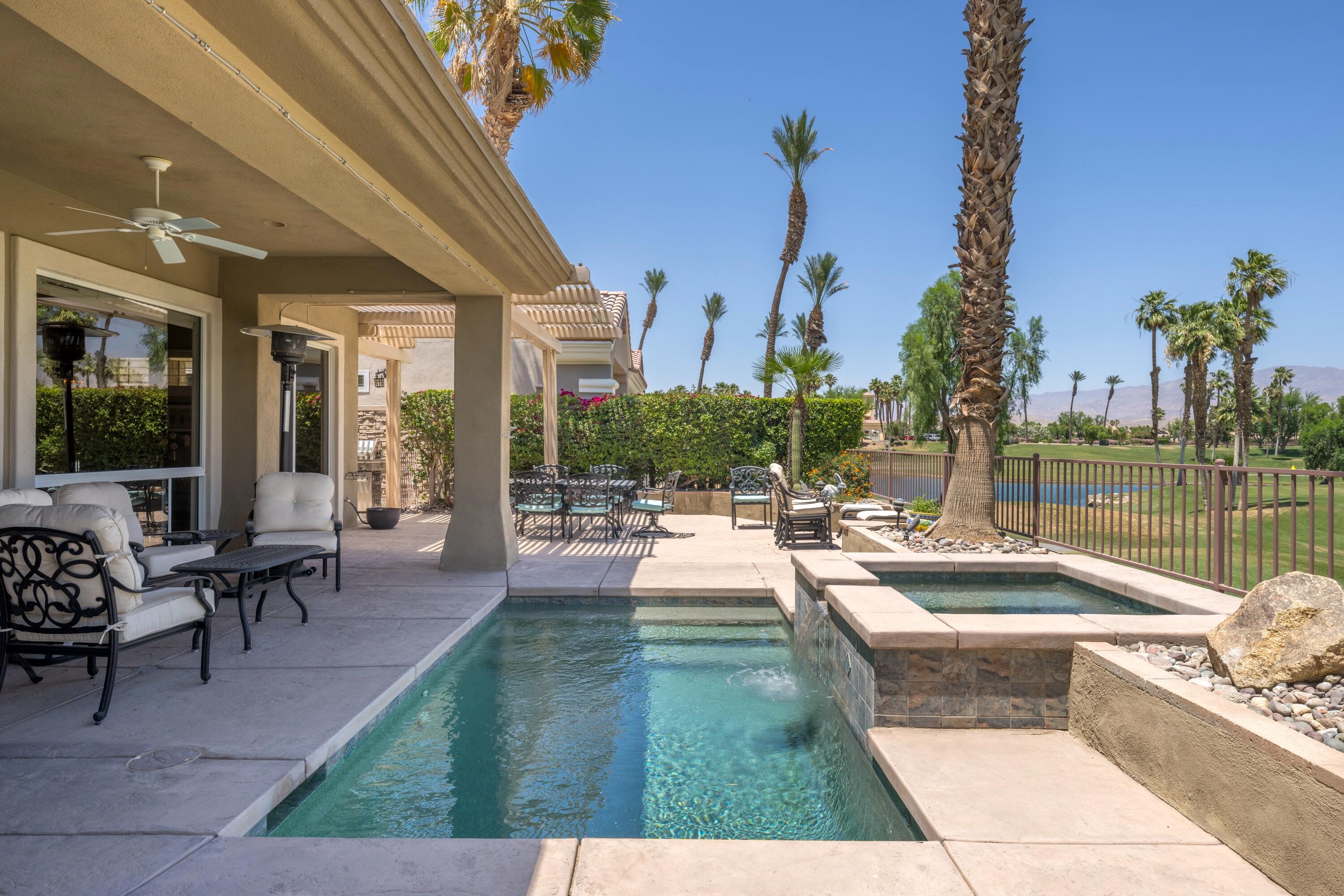 39623 Manorgate Road Palm Desert, CA 92211 - Photo 6 of 42 a view of a patio with dining table and chairs with fire pit