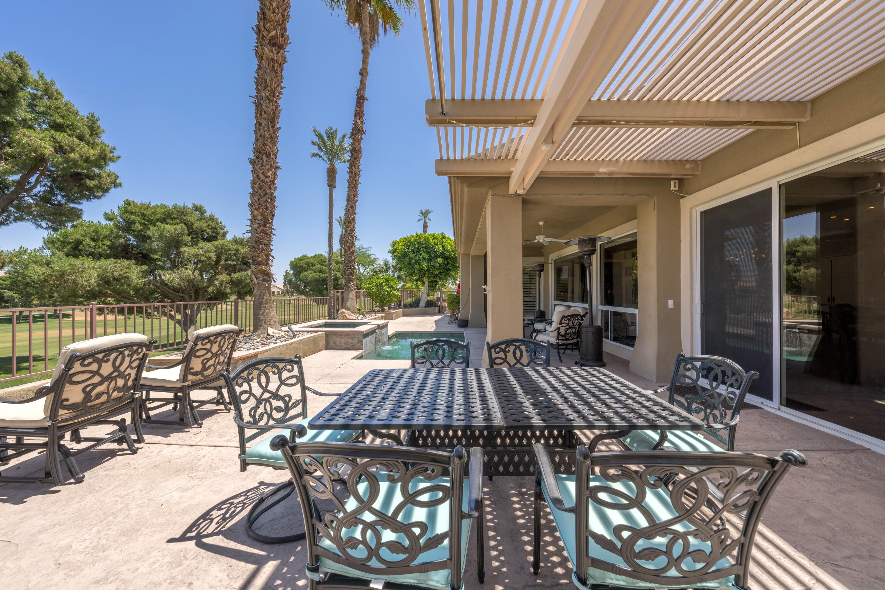 39623 Manorgate Road Palm Desert, CA 92211 - Photo 8 of 42 a view of a patio with table and chairs and potted plants