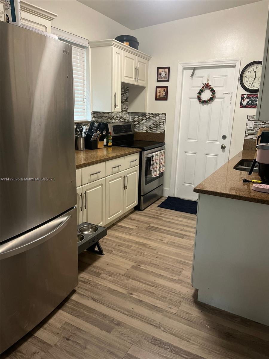3101 Southwest 18th Street Miami, FL 33145 - Photo 9 of 11 a room with a refrigerator and a sink