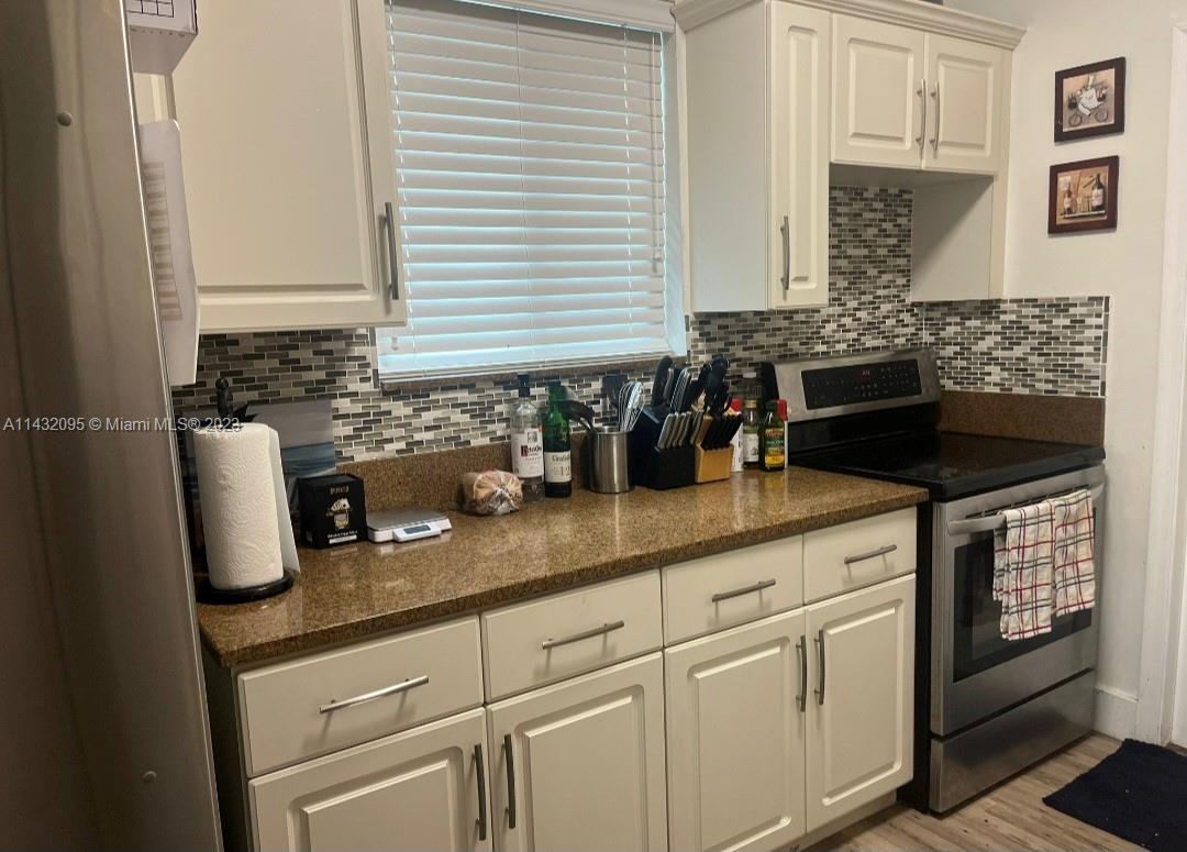3101 Southwest 18th Street Miami, FL 33145 - Photo 10 of 11 a kitchen with granite countertop a sink a stove and cabinets