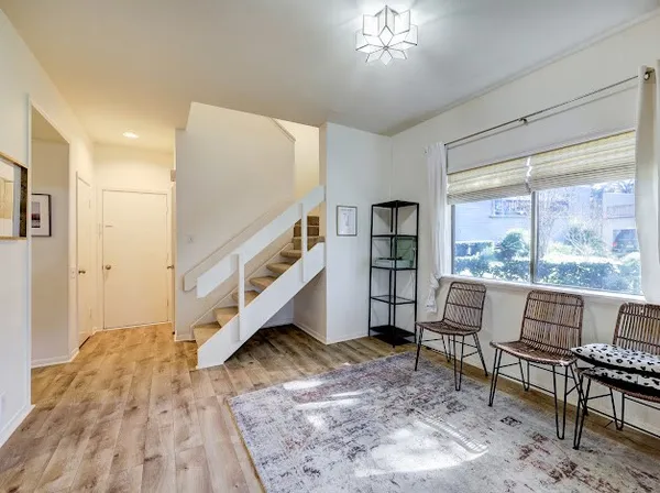 a living room with furniture and a floor to ceiling window