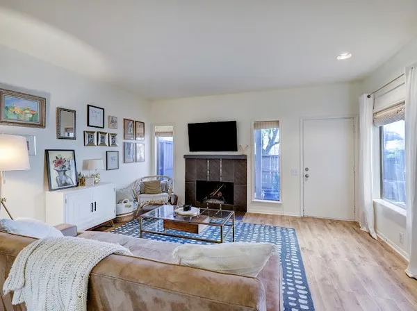 a living room with furniture a fireplace and a flat screen tv