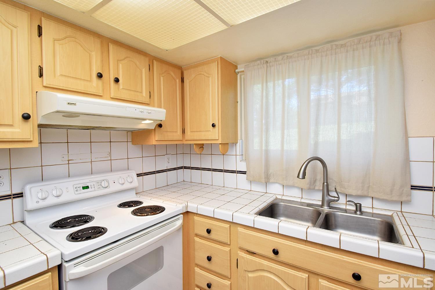 1113 Frontier Court Reno, NV 89503 - Photo 12 of 40 a kitchen with a sink and cabinets