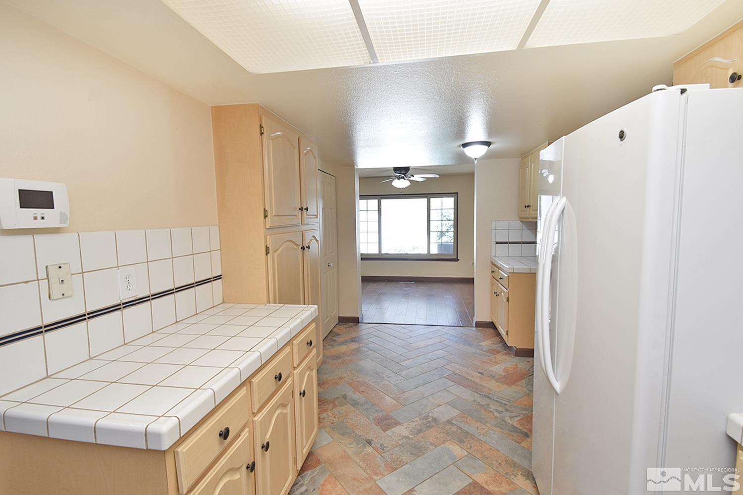 1113 Frontier Court Reno, NV 89503 - Photo 13 of 40 a kitchen with a refrigerator and a stove