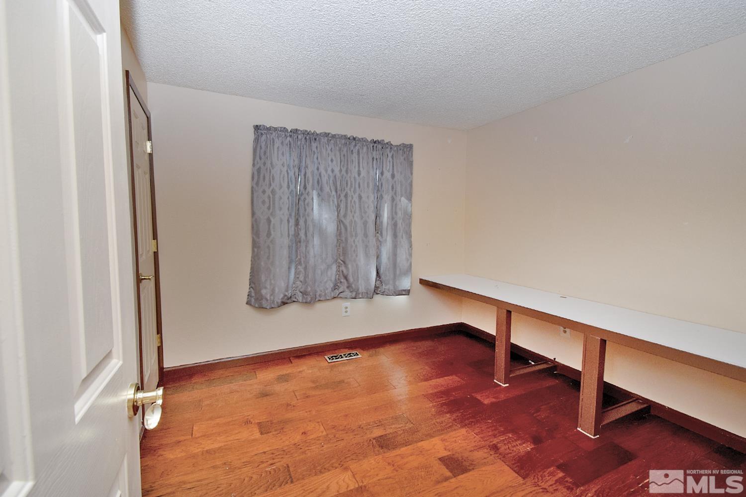 1113 Frontier Court Reno, NV 89503 - Photo 19 of 40 a view of an empty room with wooden floor