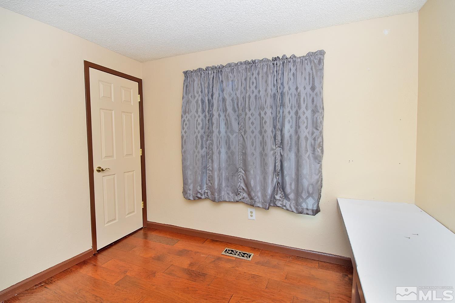 1113 Frontier Court Reno, NV 89503 - Photo 20 of 40 a view of room with window and a wooden floor