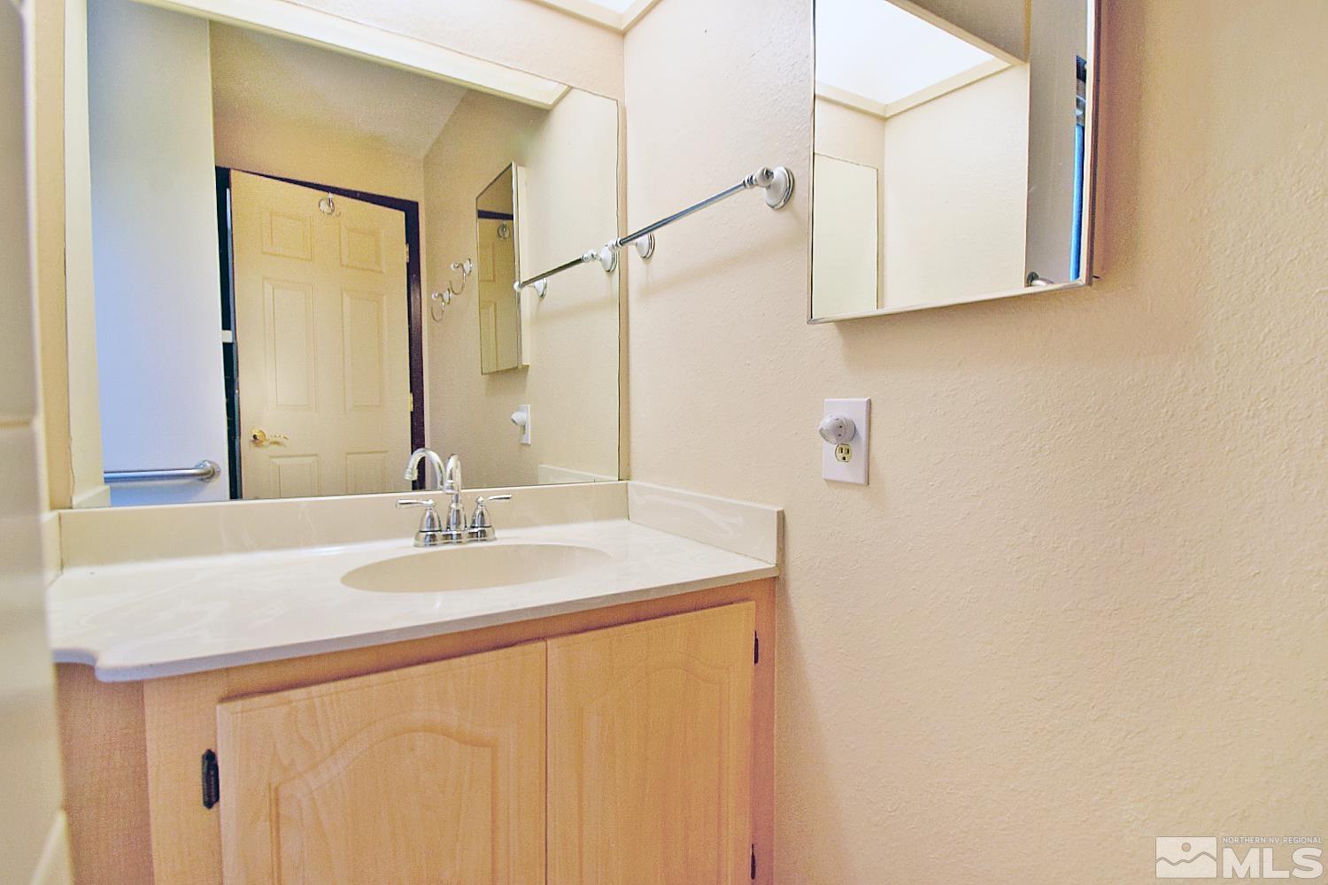 1113 Frontier Court Reno, NV 89503 - Photo 23 of 40 a bathroom with a sink and a mirror