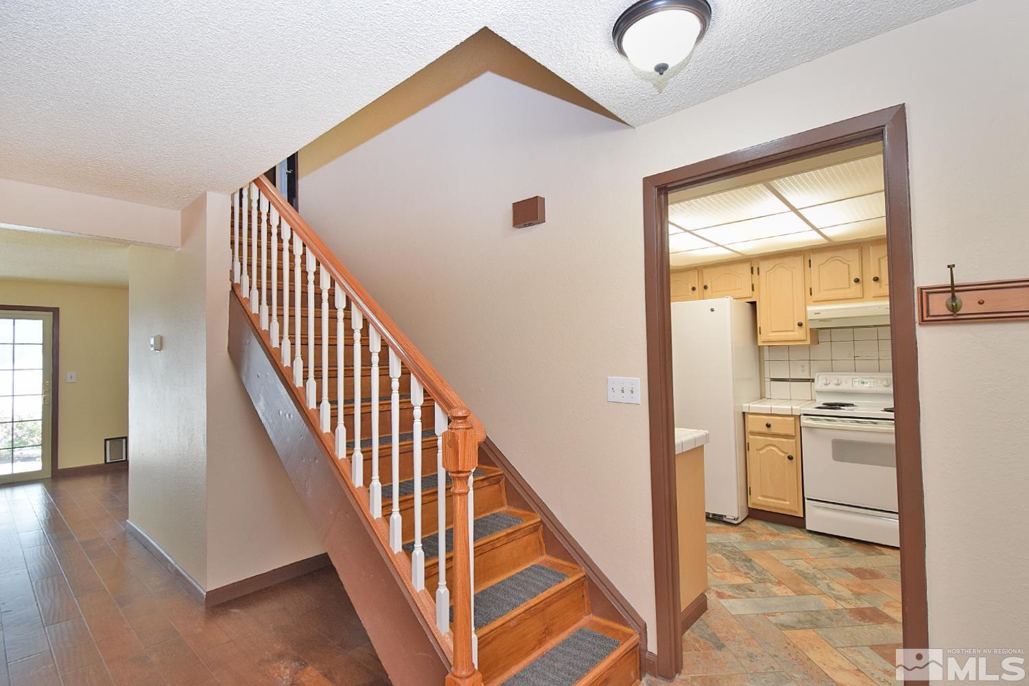 1113 Frontier Court Reno, NV 89503 - Photo 24 of 40 a view of a hallway with stainless steel appliances kitchen island