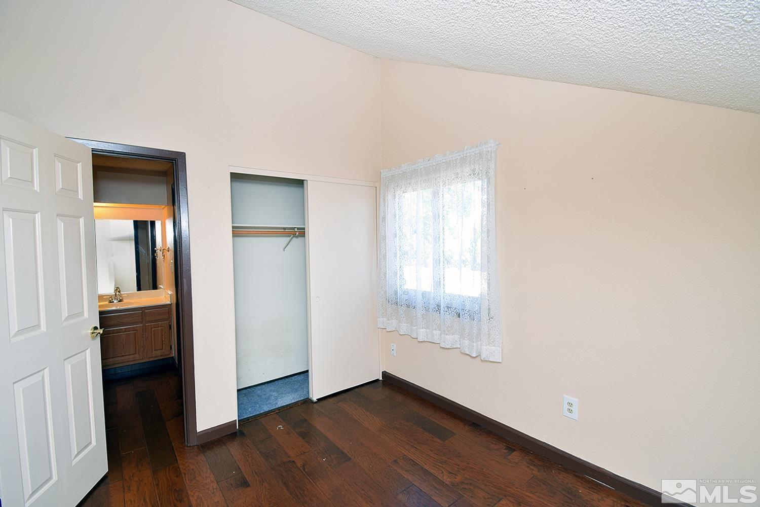 1113 Frontier Court Reno, NV 89503 - Photo 25 of 40 an empty room with wooden floor and windows