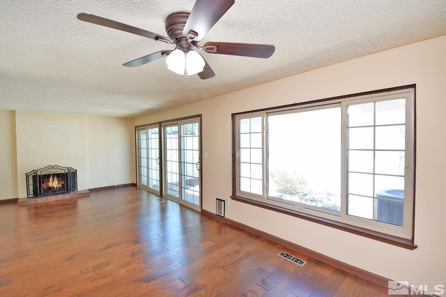 1113 Frontier Court Reno, NV 89503 - Photo 7 of 40 a view of an empty room with a window and wooden floor