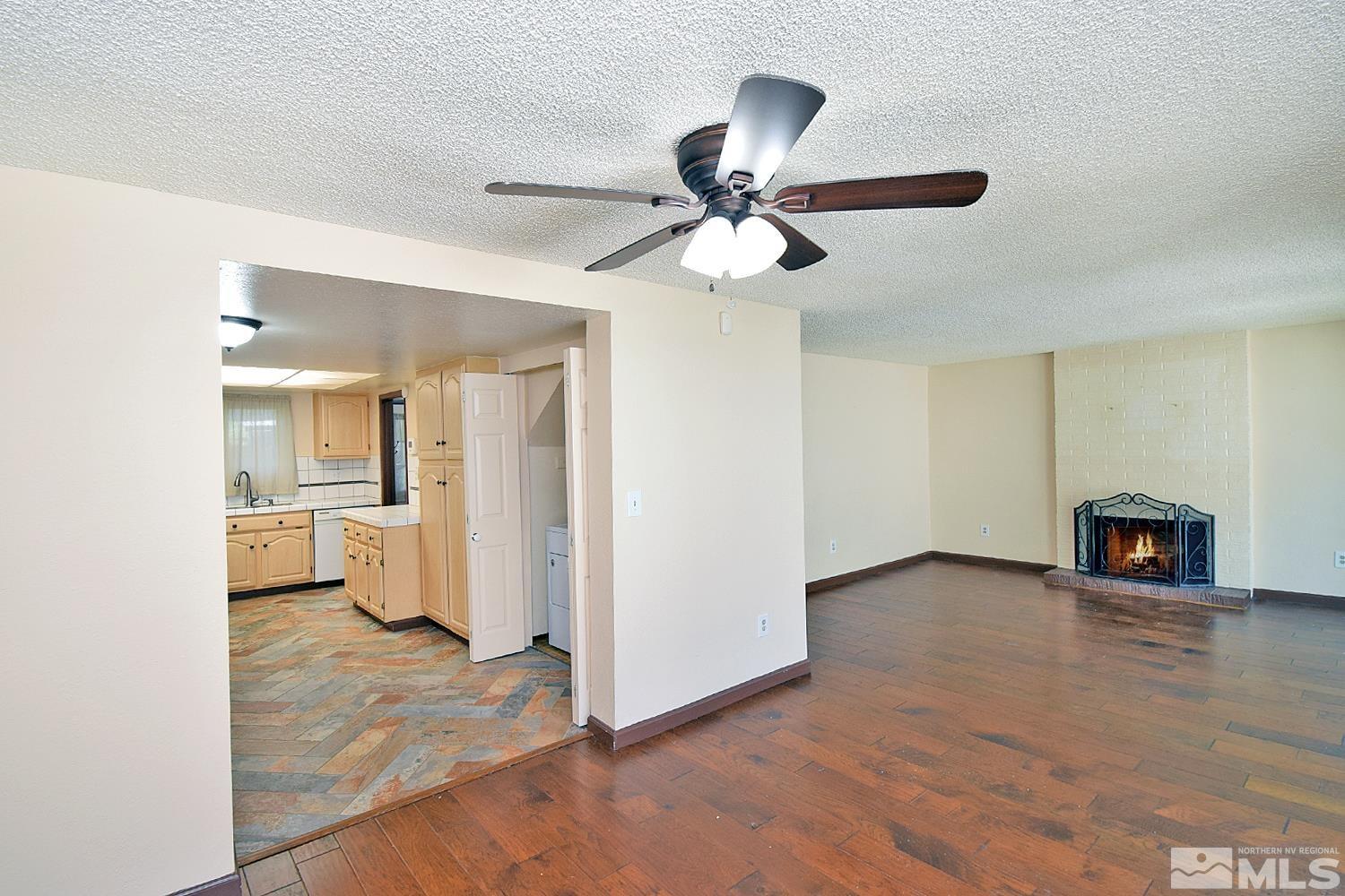 1113 Frontier Court Reno, NV 89503 - Photo 8 of 40 a view of a livingroom with wooden floor and a ceiling fan