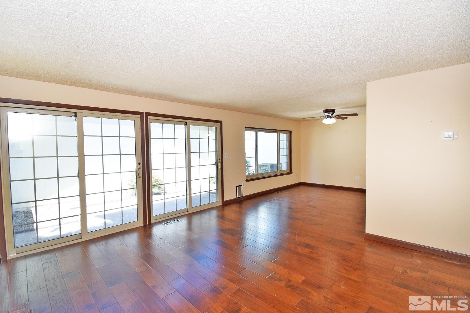 1113 Frontier Court Reno, NV 89503 - Photo 9 of 40 wooden floor in an empty room with a window