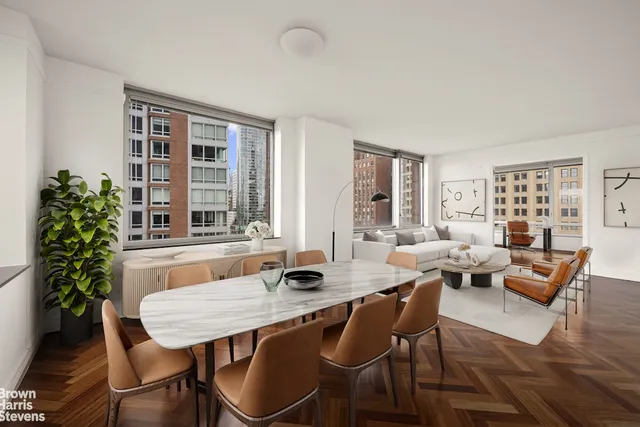 a living room with furniture and large windows