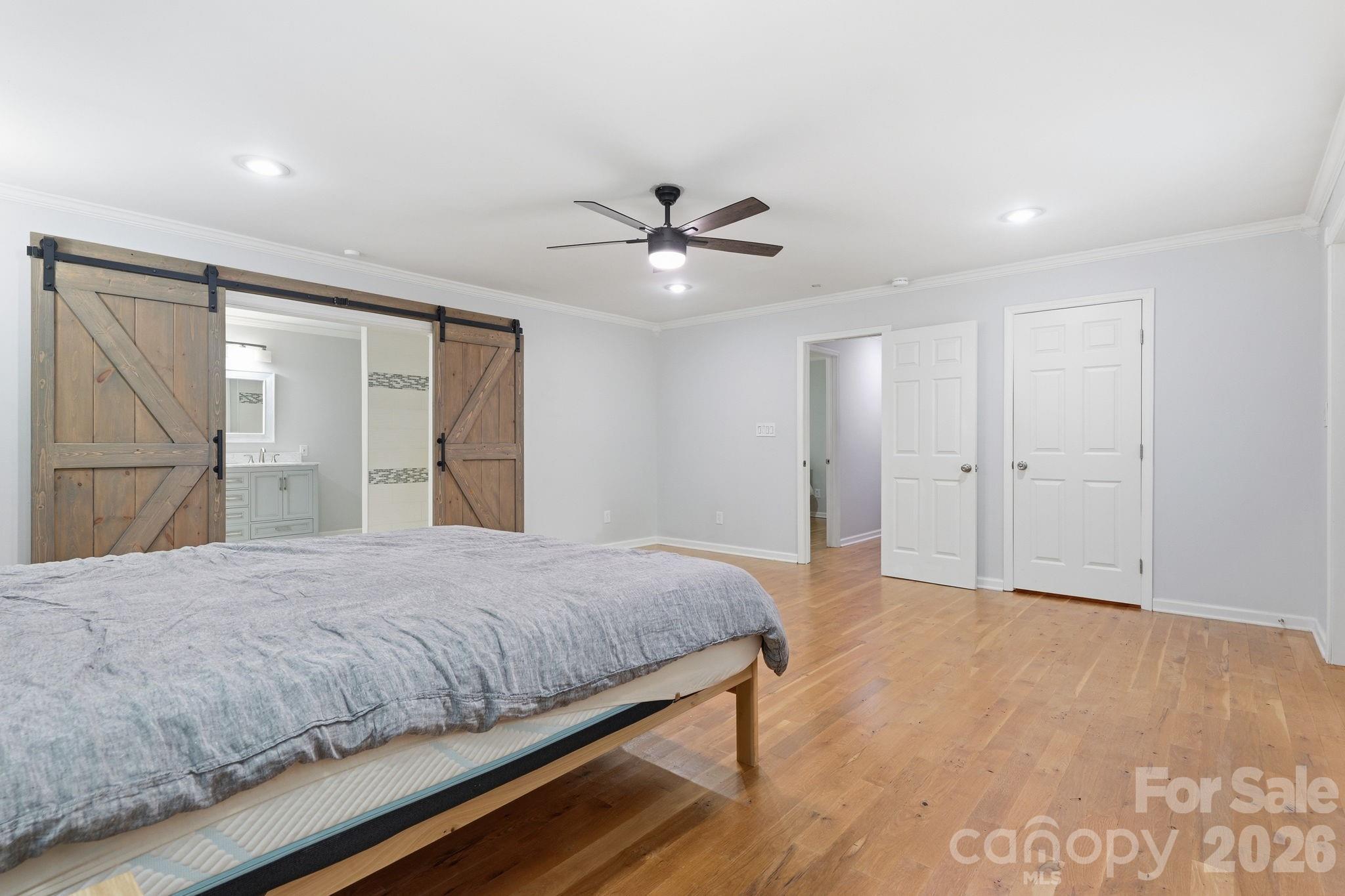 5347 Haney Road York, SC 29745 - Photo 19 of 39 a bedroom with a large bed and a chandelier fan
