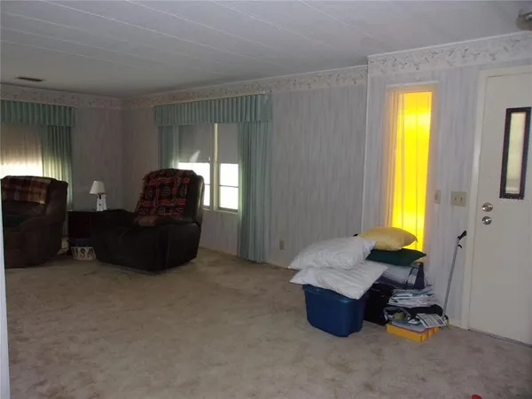 a view of a room with a large window and chandelier
