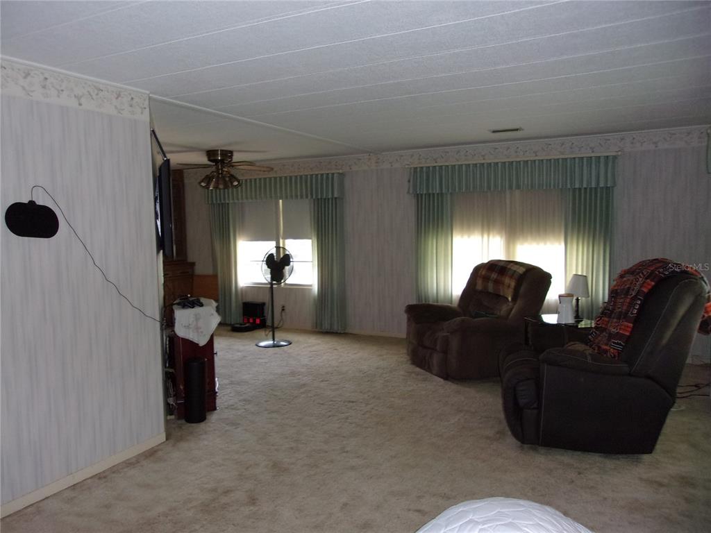 6485 Northeast 2nd Street Ocala, FL 34470 - Photo 21 of 55 a living room with furniture and a window