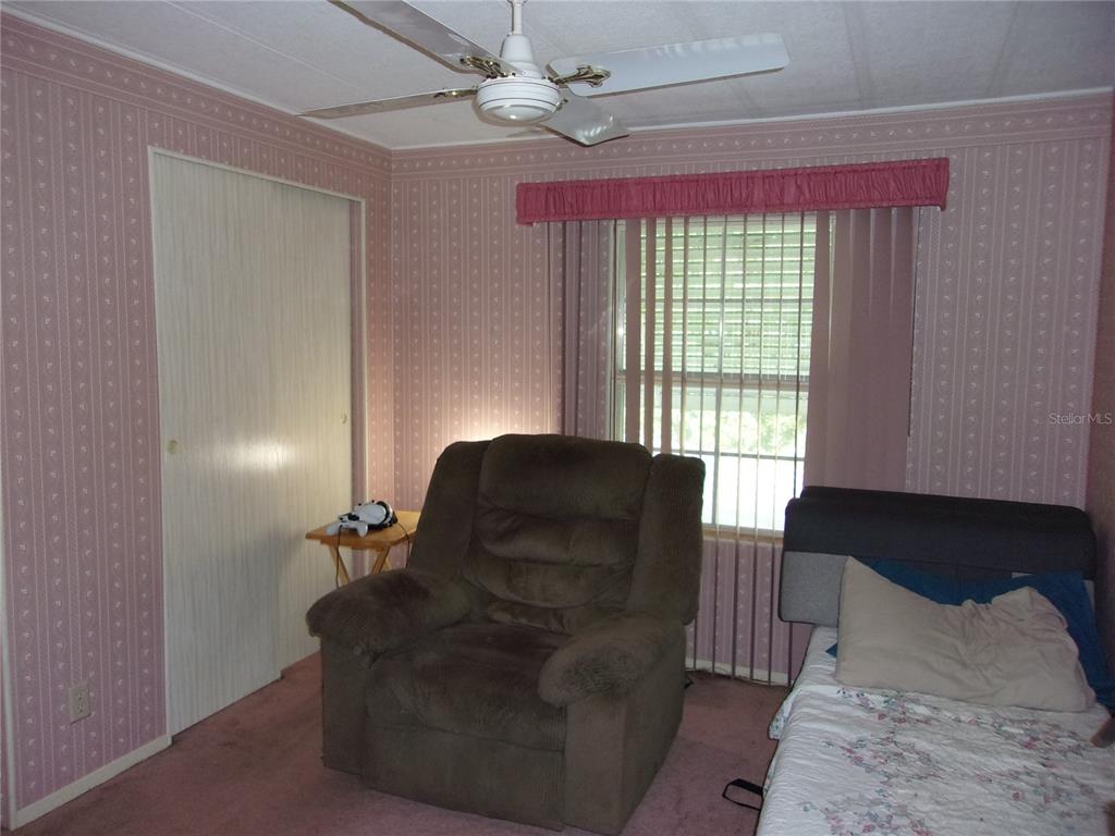 6485 Northeast 2nd Street Ocala, FL 34470 - Photo 26 of 55 a living room with furniture and a window