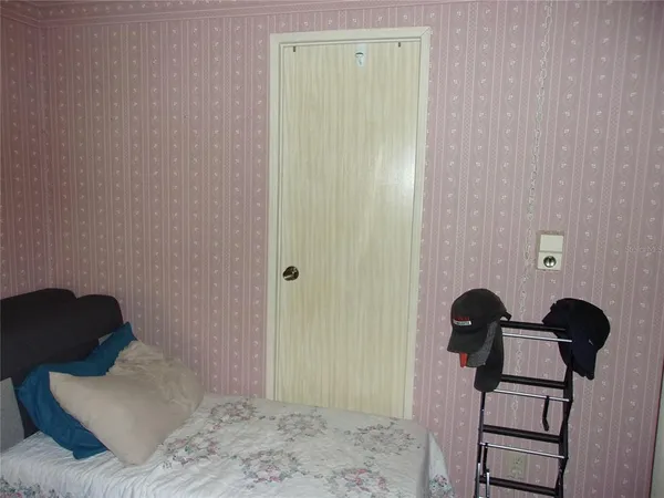 a bed sitting in a bedroom next to a window