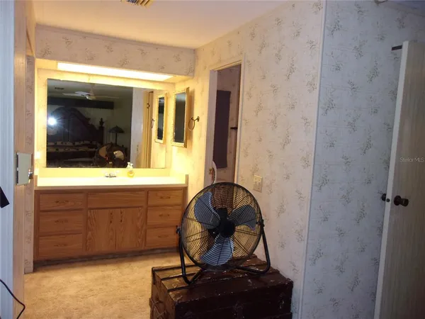 a kitchen with stainless steel appliances granite countertop a refrigerator a sink dishwasher and a stove with wooden floor