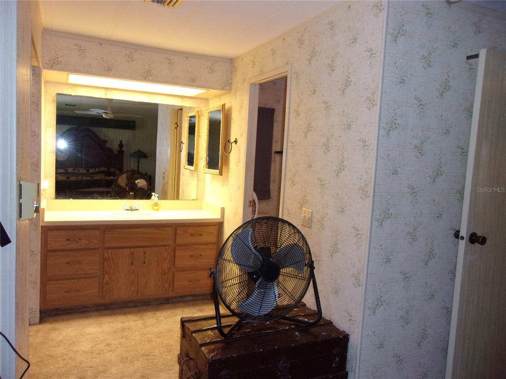 6485 Northeast 2nd Street Ocala, FL 34470 - Photo 34 of 55 a bathroom with a sink a vanity and a mirror