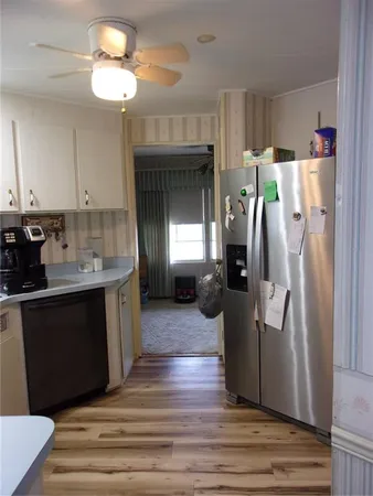 a kitchen with white cabinets and a stove with a sink