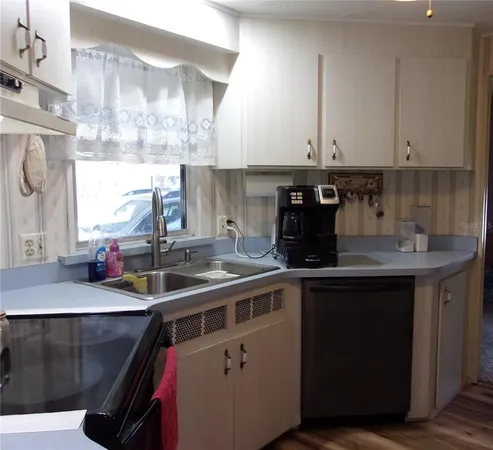 a kitchen with refrigerator and cabinets