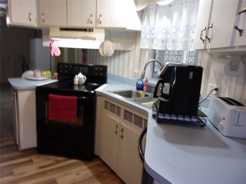 6485 Northeast 2nd Street Ocala, FL 34470 - Photo 40 of 55 a kitchen with stainless steel appliances granite countertop a sink a stove and a refrigerator