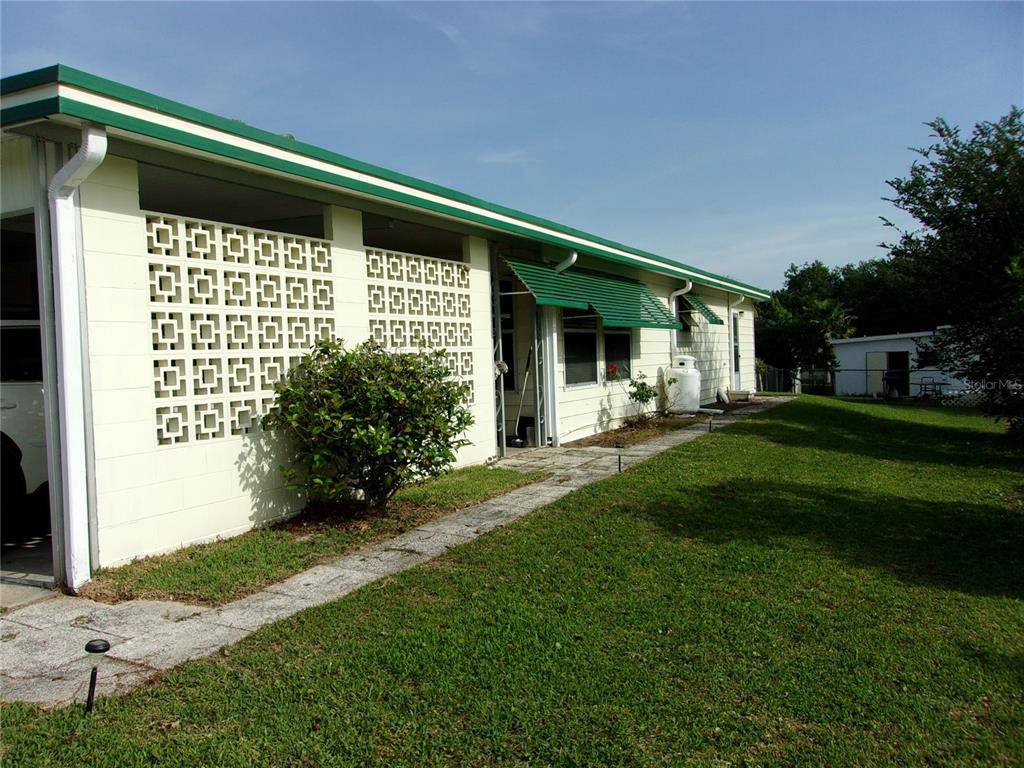 6485 Northeast 2nd Street Ocala, FL 34470 - Photo 4 of 55 a front view of a house with a yard