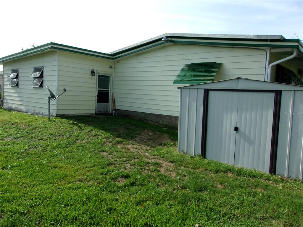 6485 Northeast 2nd Street Ocala, FL 34470 - Photo 9 of 55 a front view of a house with garden