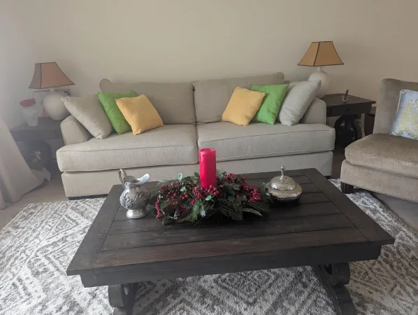 a living room with furniture and flowers