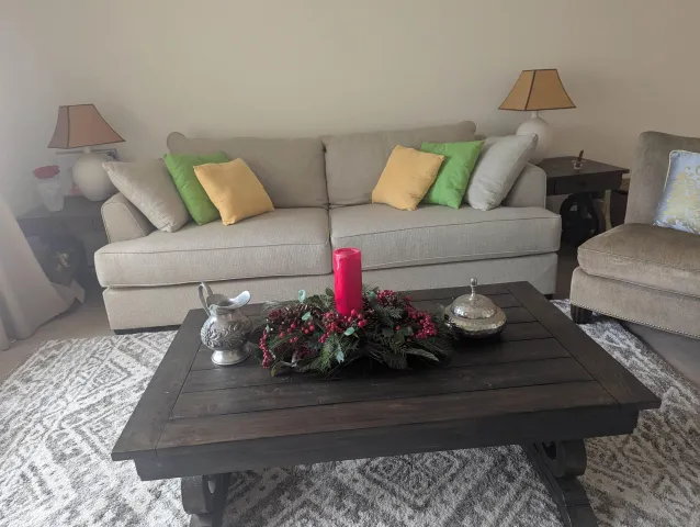 a living room with furniture and flowers