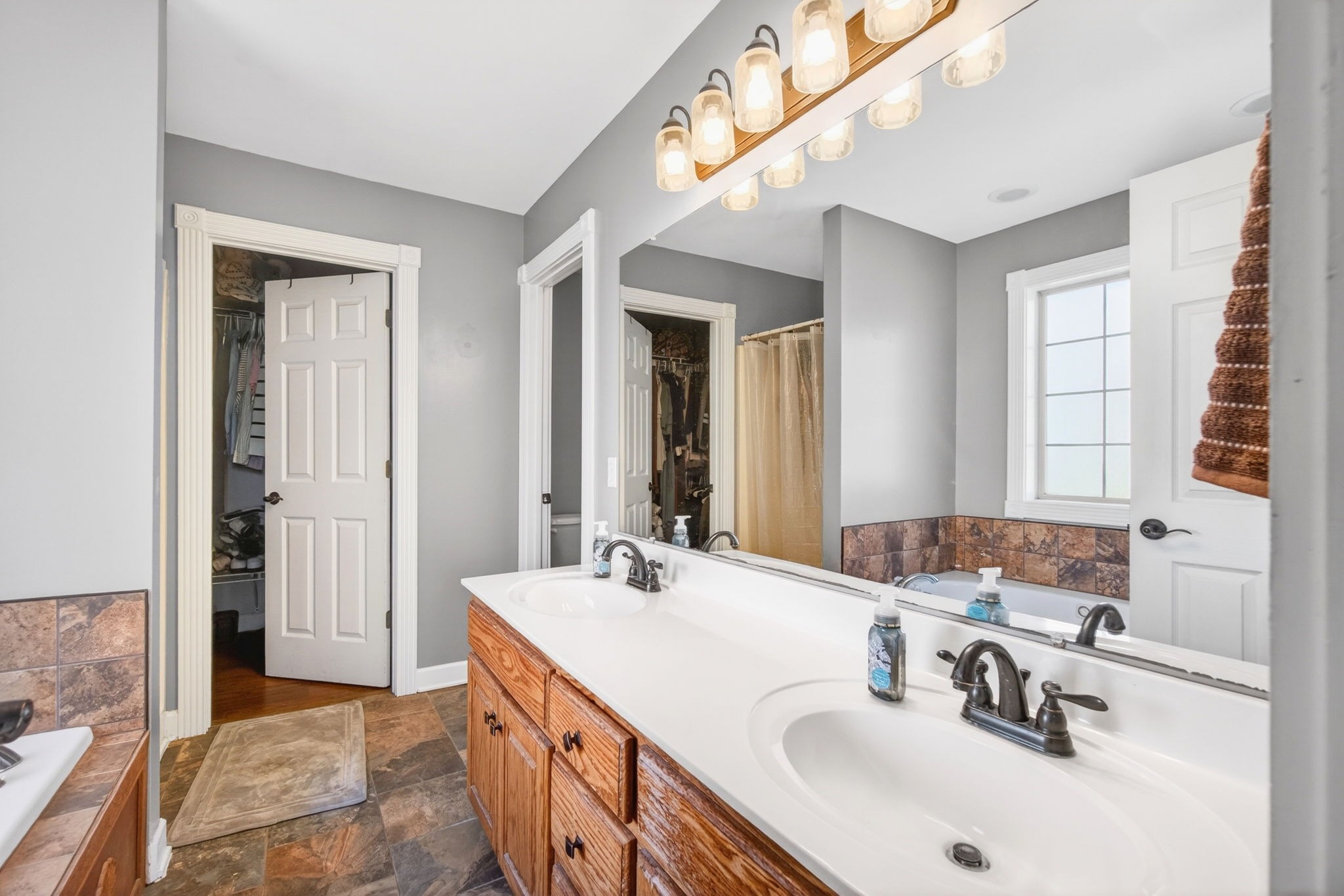 3432 WJ Robinson Road Cookeville, TN 38506 - Photo 11 of 32 a bathroom with a sink double vanity and a mirror