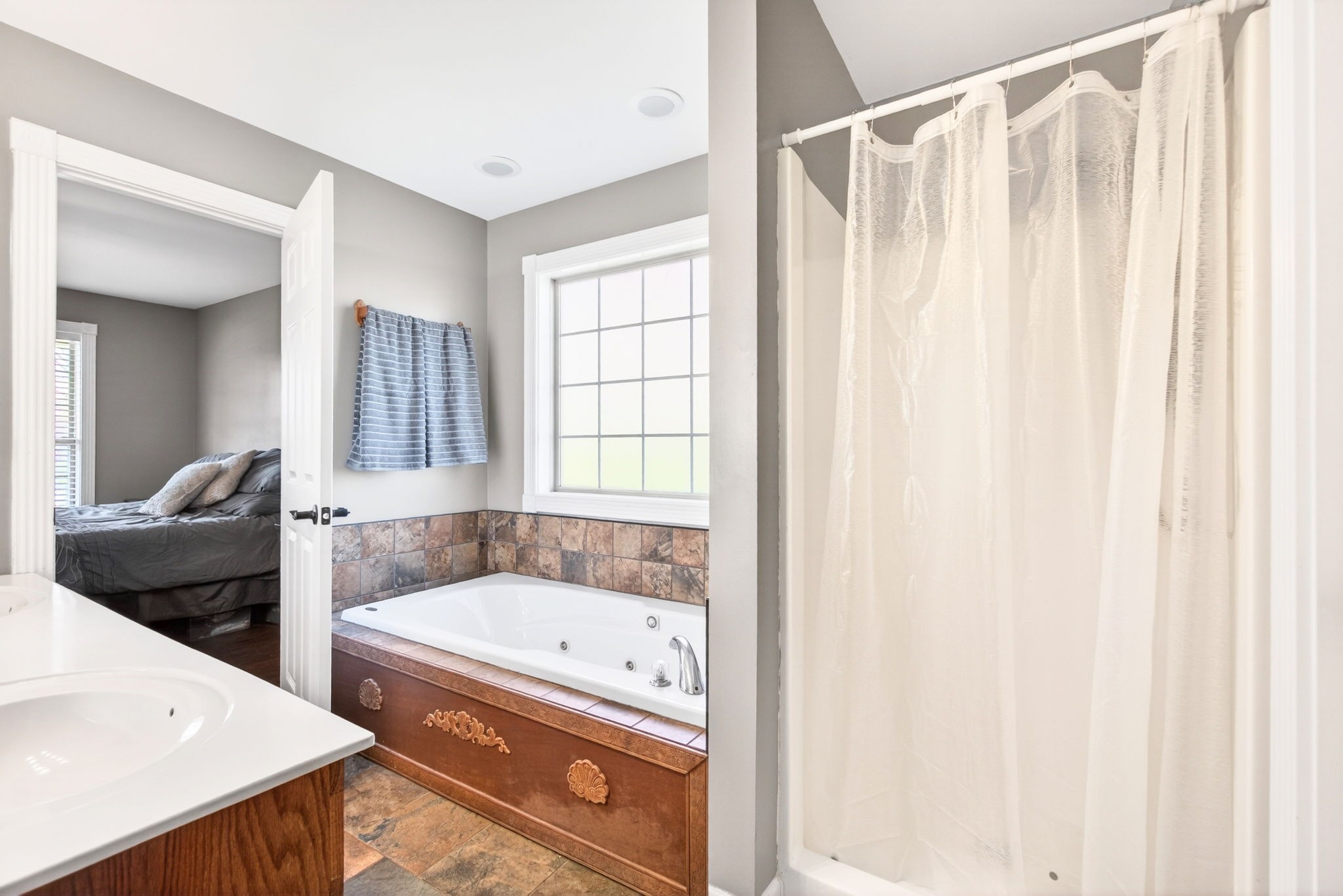 3432 WJ Robinson Road Cookeville, TN 38506 - Photo 12 of 32 a bathroom with a tub and a window