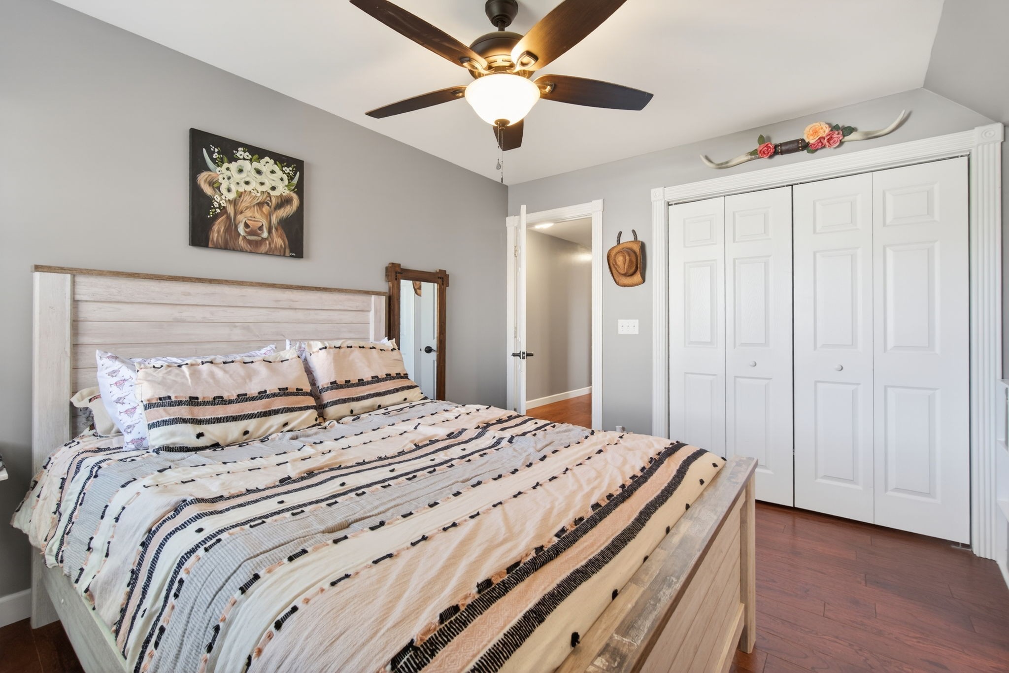 3432 WJ Robinson Road Cookeville, TN 38506 - Photo 17 of 32 a bedroom with a bed and a chandelier